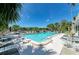 Community swimming pool surrounded by lush landscaping and lounge chairs, perfect for relaxation at 5395 Lake Arrowhead Trl # 24, Sarasota, FL 34231