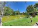 Scenic view of the lake with fountain and lush green landscaping from the lawn at 5395 Lake Arrowhead Trl # 24, Sarasota, FL 34231