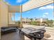 Relax on this balcony with lounge chairs, offering stunning views of the nearby ocean and tropical landscaping at 548 Beach Rd # 540A, Sarasota, FL 34242