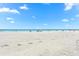 Expansive view of the sandy beach, crystal clear ocean, and sunny skies at 548 Beach Rd # 540A, Sarasota, FL 34242