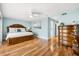A comfortable bedroom has a ceiling fan and hardwood floors at 548 Beach Rd # 540A, Sarasota, FL 34242