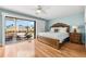 A comfortable bedroom has a ceiling fan and deck access at 548 Beach Rd # 540A, Sarasota, FL 34242