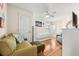 Bright bedroom featuring a comfortable sofa, daybed, and stylish ceiling fan, creating a relaxing space at 548 Beach Rd # 540A, Sarasota, FL 34242