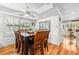 An elegant dining room boasts hardwood floors, bright windows, and a wooden dining set at 548 Beach Rd # 540A, Sarasota, FL 34242