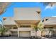 Unique and modern exterior elevation showcases a two-story home with neutral siding and manicured landscaping at 548 Beach Rd # 540A, Sarasota, FL 34242