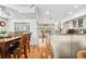 Open-concept kitchen with stainless steel appliances, granite countertops, and seamless flow to the dining area at 548 Beach Rd # 540A, Sarasota, FL 34242