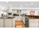 Stylish kitchen featuring stainless steel appliances, granite countertops, hardwood floors, and white cabinetry at 548 Beach Rd # 540A, Sarasota, FL 34242