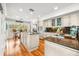 Large kitchen featuring stainless steel appliances, granite countertops, hardwood floors, and plenty of storage at 548 Beach Rd # 540A, Sarasota, FL 34242