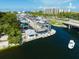 Aerial view of a marina showcasing boat storage, a lifting dock and waterfront access amidst a beautiful coastal setting at 548 Beach Rd # 540A, Sarasota, FL 34242