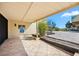 Inviting covered patio with tile flooring, beach sign, and convenient access to the outdoors at 548 Beach Rd # 540A, Sarasota, FL 34242