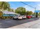 Exterior of a restaurant with ample parking space and inviting outdoor seating under a stylish blue and white awning at 548 Beach Rd # 540A, Sarasota, FL 34242