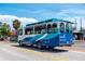 Public transport shuttle with blue and white design parked on a sunny street ready to transport passengers at 548 Beach Rd # 540A, Sarasota, FL 34242