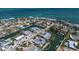 Aerial view of waterfront home with a pool, surrounded by lush landscaping and canal access at 606 Emerald Ln, Holmes Beach, FL 34217