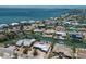 Scenic aerial view of waterfront neighborhood showcasing canals, homes, and blue ocean water at 606 Emerald Ln, Holmes Beach, FL 34217
