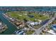 Aerial view of a golf course community with waterfront homes, lush fairways, and scenic surroundings at 606 Emerald Ln, Holmes Beach, FL 34217