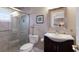 Updated bathroom featuring tiled walk-in shower and vanity with decorative mirror and accents at 606 Emerald Ln, Holmes Beach, FL 34217