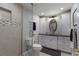 Modern bathroom with walk-in shower, white cabinetry, and sleek fixtures at 606 Emerald Ln, Holmes Beach, FL 34217