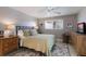 Inviting bedroom featuring area rug, bedside tables, a ceiling fan, and ample natural light at 606 Emerald Ln, Holmes Beach, FL 34217