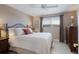 Comfortable bedroom with a large window, ceiling fan, bedside tables, and closet at 606 Emerald Ln, Holmes Beach, FL 34217