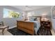 Bright bedroom with a view, stylish rug, and coordinated furnishings at 606 Emerald Ln, Holmes Beach, FL 34217