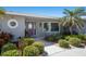 Close up of charming entryway featuring colorful front door and mature landscaping at 606 Emerald Ln, Holmes Beach, FL 34217
