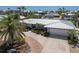 Beautiful home featuring lush landscaping, a pristine white roof, and an attached two-car garage at 606 Emerald Ln, Holmes Beach, FL 34217