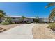 Attractive home with lovely landscaping and unique front door design at 606 Emerald Ln, Holmes Beach, FL 34217