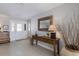 Welcoming foyer features tile flooring, a wooden console table, and a mirror at 606 Emerald Ln, Holmes Beach, FL 34217