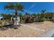 Beautiful front yard with palm trees, gravel, and stone walkway leading to a well-maintained home at 606 Emerald Ln, Holmes Beach, FL 34217