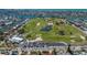 Aerial view of the lush golf course in a waterfront community, featuring manicured greens and scenic views at 606 Emerald Ln, Holmes Beach, FL 34217
