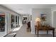 Hallway with a view of an outdoor seating area, office, and large windows at 606 Emerald Ln, Holmes Beach, FL 34217