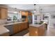 Bright kitchen boasts wood cabinets, modern appliances, and an island with cooktop and seating at 606 Emerald Ln, Holmes Beach, FL 34217
