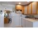 Bright laundry room with washer, dryer, and convenient built-in cabinet storage at 606 Emerald Ln, Holmes Beach, FL 34217