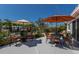 Outdoor patio with umbrella-covered seating and a view of the water and landscaped yard at 606 Emerald Ln, Holmes Beach, FL 34217