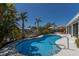 Gorgeous pool in tropical landscaped backyard with patio and dock at 606 Emerald Ln, Holmes Beach, FL 34217