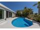 Private kidney-shaped pool with tropical landscaping creating a serene backyard oasis at 606 Emerald Ln, Holmes Beach, FL 34217