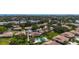 Expansive aerial view of a residential community with lush greenery, pools, and serene water features near the ocean at 6102 Penny Ln, Bradenton, FL 34207