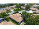 Aerial view of a residential neighborhood with homes, green spaces, and a nearby pond at 6102 Penny Ln, Bradenton, FL 34207