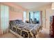 Comfortable bedroom with sunroom access, creating an inviting atmosphere at 6102 Penny Ln, Bradenton, FL 34207