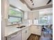 Modern kitchen with white cabinets, sleek countertops, and an open layout to the dining area at 6102 Penny Ln, Bradenton, FL 34207