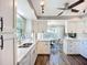 Bright, updated kitchen featuring white cabinets, stainless steel appliances, and stylish finishes at 6102 Penny Ln, Bradenton, FL 34207