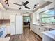 Bright kitchen with white cabinets, modern appliances, and an open layout to the rest of the home at 6102 Penny Ln, Bradenton, FL 34207