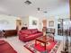Spacious living room featuring bright carpets, lots of natural light, and comfortable furniture at 6102 Penny Ln, Bradenton, FL 34207