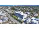 Overhead shot of a lovely condo, showing a swimming pool, landscaping, and plenty of parking for its residents at 625 Beach Rd # 207, Sarasota, FL 34242