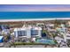 Breathtaking aerial view of beachfront condo, white sands, blue waters, and community tennis courts at 625 Beach Rd # 207, Sarasota, FL 34242