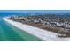 Aerial view of beachfront community showcasing the coastline, buildings, and beautiful ocean views at 625 Beach Rd # 207, Sarasota, FL 34242