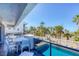 Outdoor seating with a view of palm trees and the ocean in the distance at 625 Beach Rd # 207, Sarasota, FL 34242