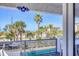 Balcony view showcases the pool and a lush, tropical landscape at 625 Beach Rd # 207, Sarasota, FL 34242
