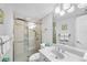 Updated bathroom with a glass shower, white vanity, and decorative mirror at 625 Beach Rd # 207, Sarasota, FL 34242