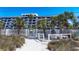 Private beach access with white picket fence and gates for residents, set amongst lush landscaping at 625 Beach Rd # 207, Sarasota, FL 34242
